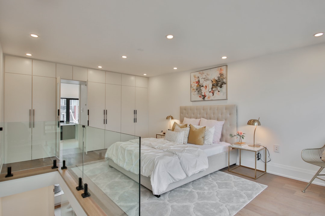 Modern bedroom with a large bed and stylish glass wall.