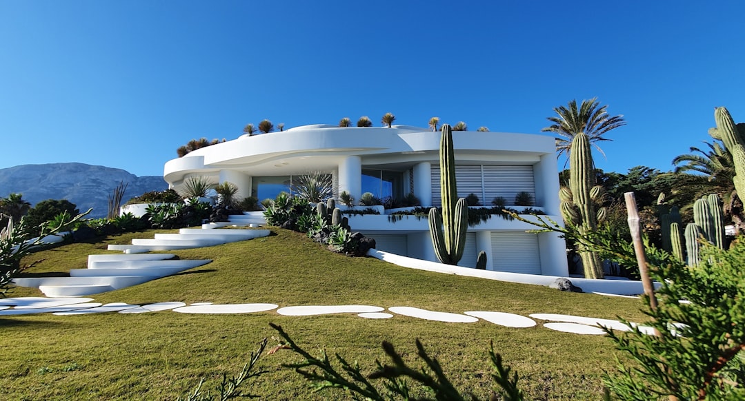 White concrete building under a blue sky during the day in Portugal.
