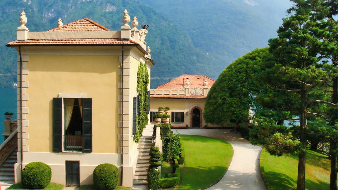 Elegant villa with manicured gardens overlooking a tranquil lake.
