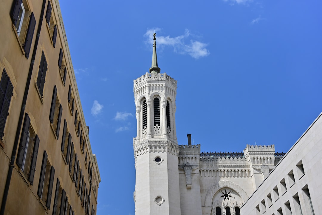 A tall white building with a clock on its facade.